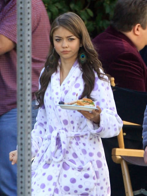 a girl in a polka-dot robe looking unimpressed